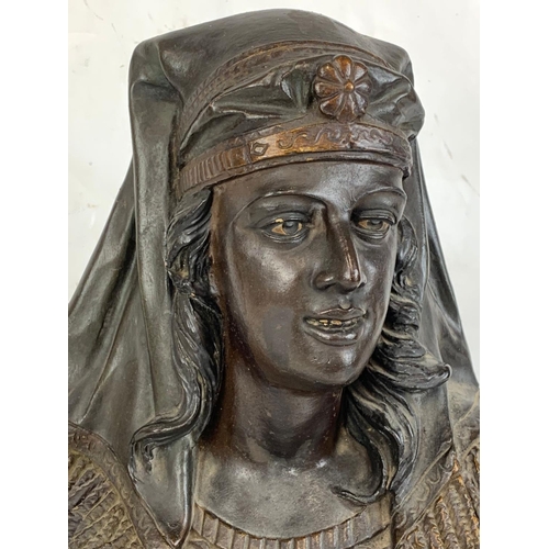 151 - A large 19th century plaster bust of a Nubian woman. Signed W. G & Co. 31 x 48cm.