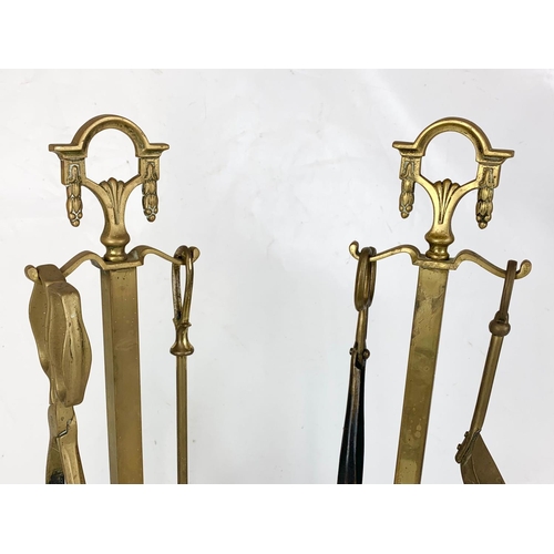 170 - A pair of Edwardian period tall brass companion sets. 57cm.