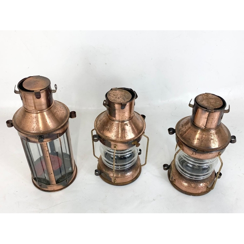 173 - 3 copper tea lights in the form of lantern. Largest 27.5cm