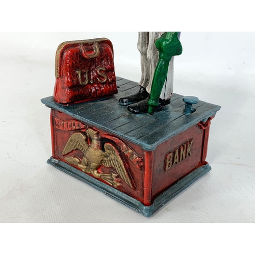 174 - An old style cast iron money box. 28cm.