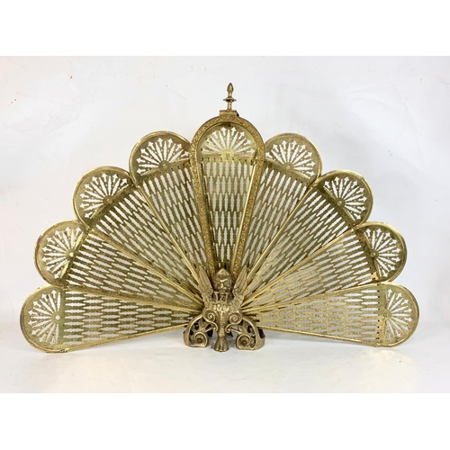 184 - A vintage brass peacock firescreen with Griffin decoration. Height 62.5cm.