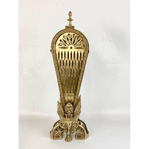 184 - A vintage brass peacock firescreen with Griffin decoration. Height 62.5cm.