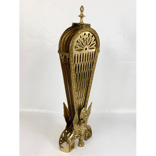 184 - A vintage brass peacock firescreen with Griffin decoration. Height 62.5cm.