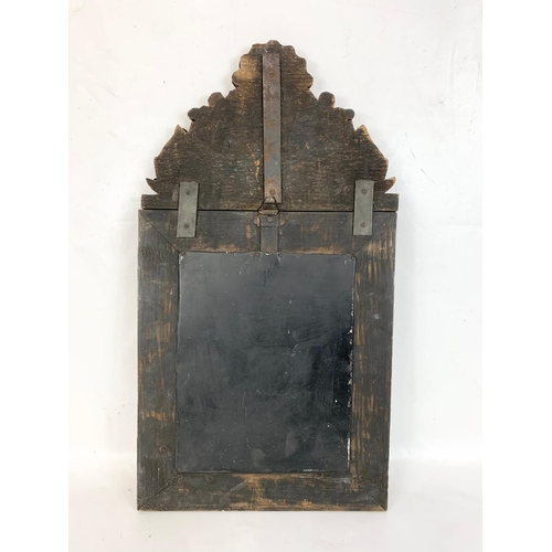 185 - An ornate brass framed bevelled mirror. 31 x 57.5cm