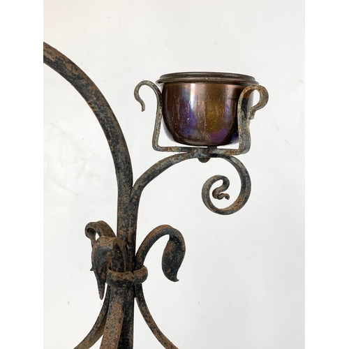 240 - An early 20th century French wrought iron candleholder. 70.5cm.