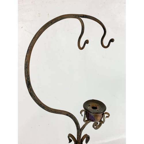 240 - An early 20th century French wrought iron candleholder. 70.5cm.