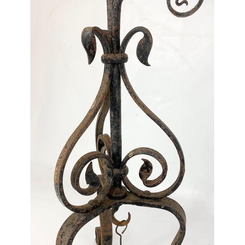 240 - An early 20th century French wrought iron candleholder. 70.5cm.