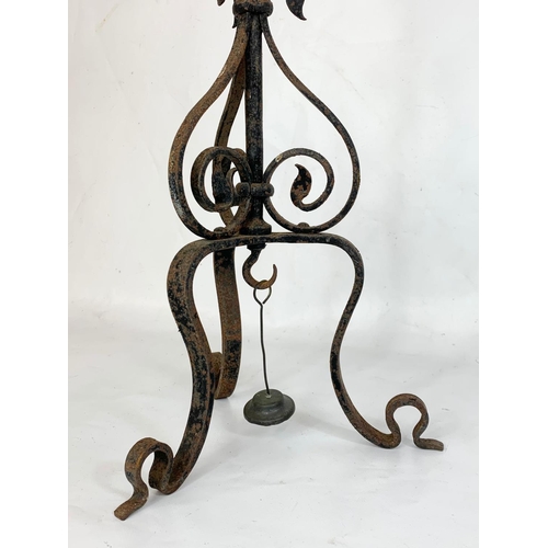 240 - An early 20th century French wrought iron candleholder. 70.5cm.