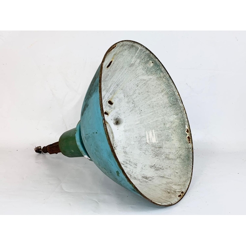 255 - A vintage industrial light fitting. 46 x 57.5cm.