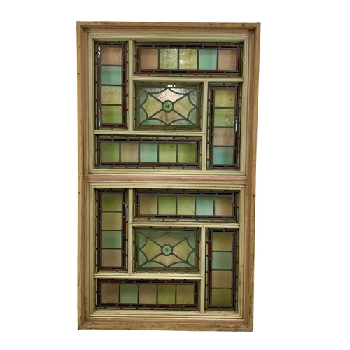 26 - A large Victorian stained glass and lead panel in wooden frame. 103 x 177.5cm.