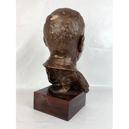 266 - A large plaster bust of Sir Bobby Charlton on wooden base. 26 x 21 x 51cm