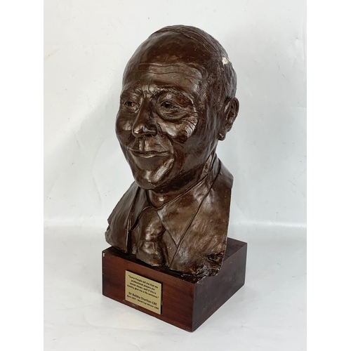 266 - A large plaster bust of Sir Bobby Charlton on wooden base. 26 x 21 x 51cm