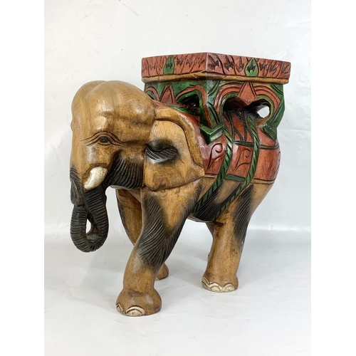 267 - A large wooden elephant jardiniere stand. 48 x 47cm