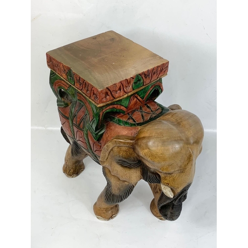 267 - A large wooden elephant jardiniere stand. 48 x 47cm