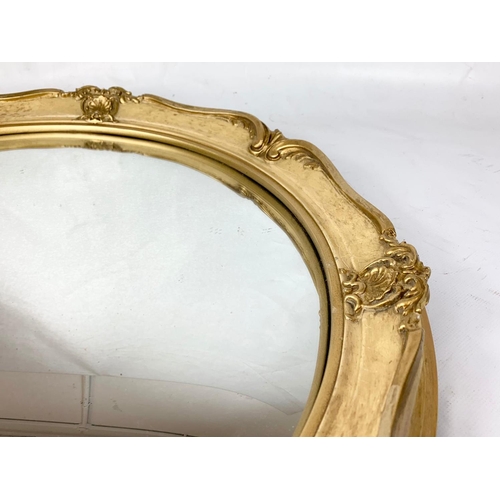 275 - A vintage ornate gilt framed mirror. 49cm.