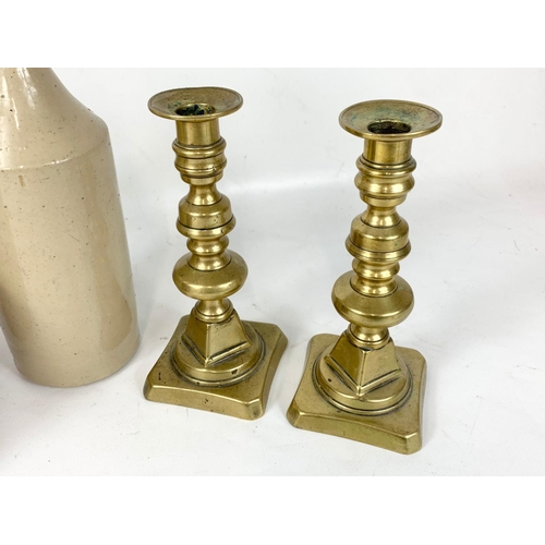 276 - A pair of Victorian brass candlesticks, a Victorian copper kettle and a vintage stone bottle. Stone ... 