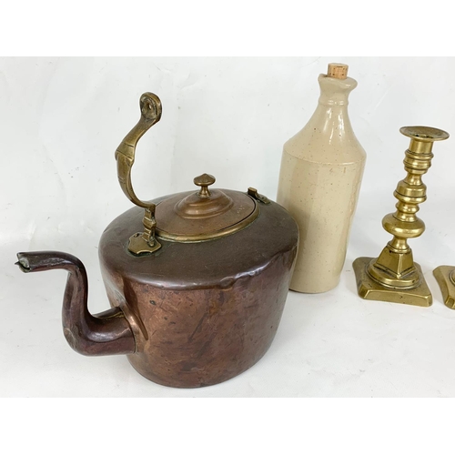 276 - A pair of Victorian brass candlesticks, a Victorian copper kettle and a vintage stone bottle. Stone ... 