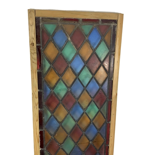 287 - A pair of large late 19th century stained glass panels. 57.5 x 179cm.