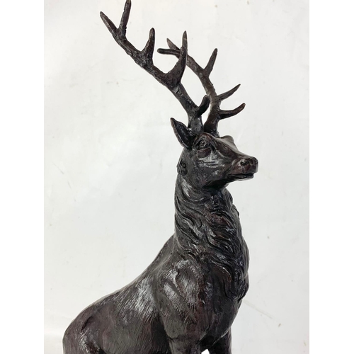 31 - A pair of large Bronze stags on marbles bases. 22 x 44cm