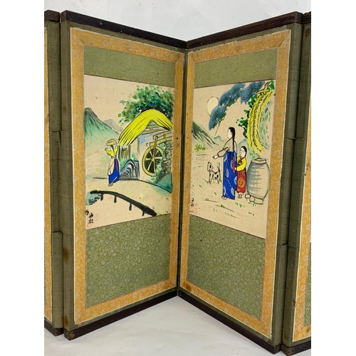 312 - A small early 20th century Japanese folding screen with hand painted watercolour panels. 114 x 38cm.