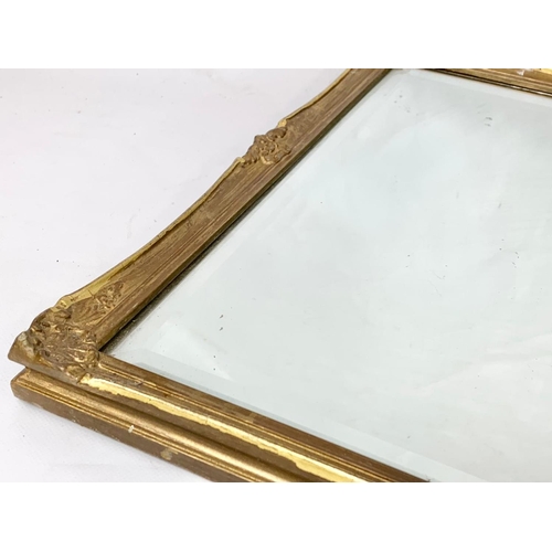 313 - A vintage ornate gilt framed mirror. 74 x 41cm