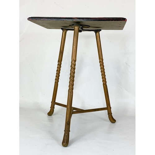 320 - A small Victorian brass table with revolving top. 38 x 47cm