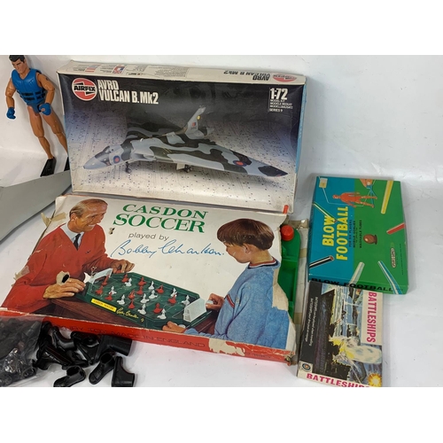 336a - A quantity of toys and games. Including Casdon Soccer game, Bobby Charlton, Action Man figure and bo... 