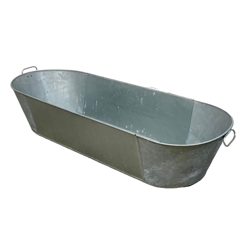 354f - A large galvanised bath. 148 x 53.5 x 31cm