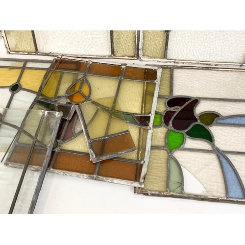 355 - A quantity of late 19th century stained glass. Largest 76cm.