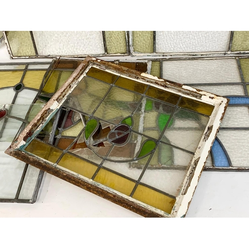 355 - A quantity of late 19th century stained glass. Largest 76cm.