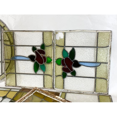 355 - A quantity of late 19th century stained glass. Largest 76cm.