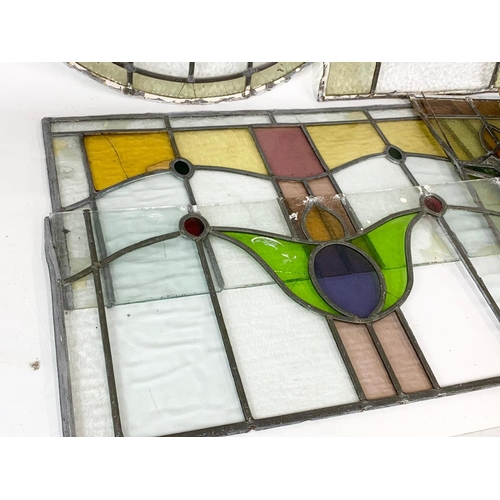 355 - A quantity of late 19th century stained glass. Largest 76cm.