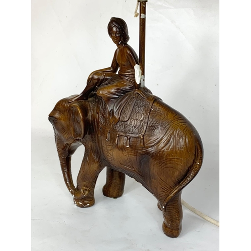 360 - A vintage plaster elephant table lamp with shade. 29 x 59cm