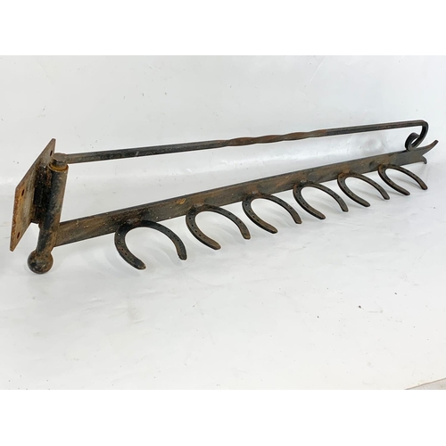 370 - An iron wall mount, 102cm.