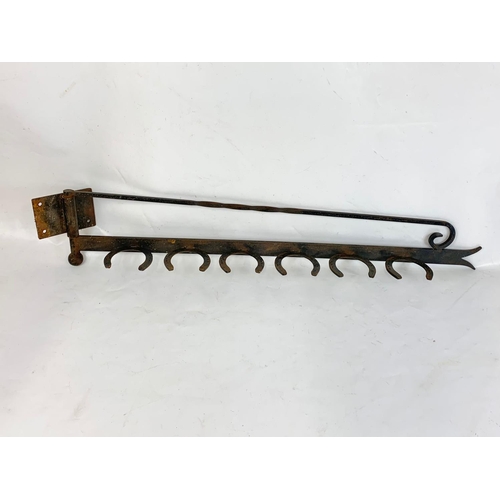 370 - An iron wall mount, 102cm.