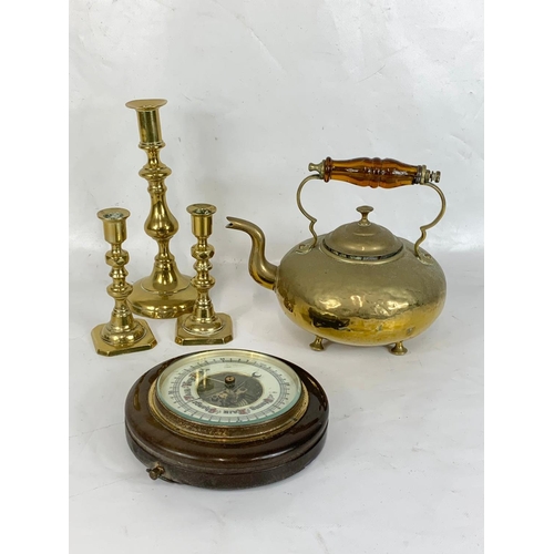 387 - A quantity of Victorian brassware and a barometer.