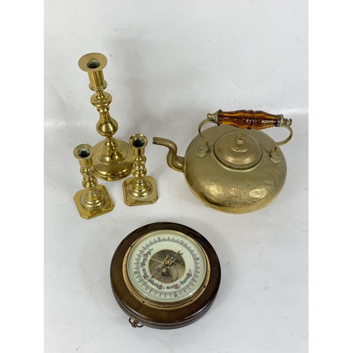 387 - A quantity of Victorian brassware and a barometer.