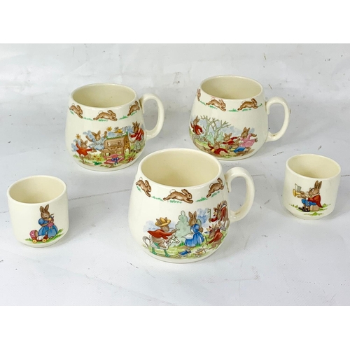 405 - 9 pieces of Royal Doulton Bunnykins pottery. A pair of plates, a pair of bowls, 3 mugs and 2 egg cup... 