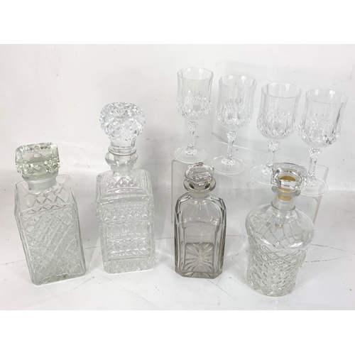 469 - 4 decanters and a set of 4 crystal wine glasses.