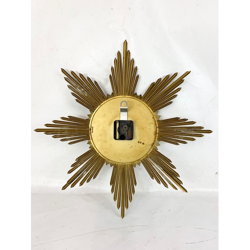 47 - A 1960’s Mid Century Sunburst wall clock by Junghans Prescott. 50cm.