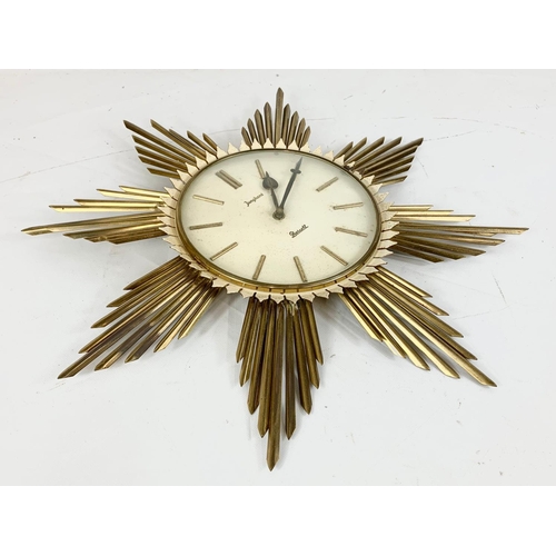 47 - A 1960’s Mid Century Sunburst wall clock by Junghans Prescott. 50cm.