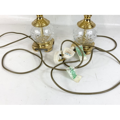 477 - A pair of crystal and brass table lamps. 39cm including shade.