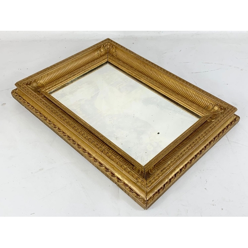 48 - A vintage gilt framed mirror. 32 x 42.5cm.