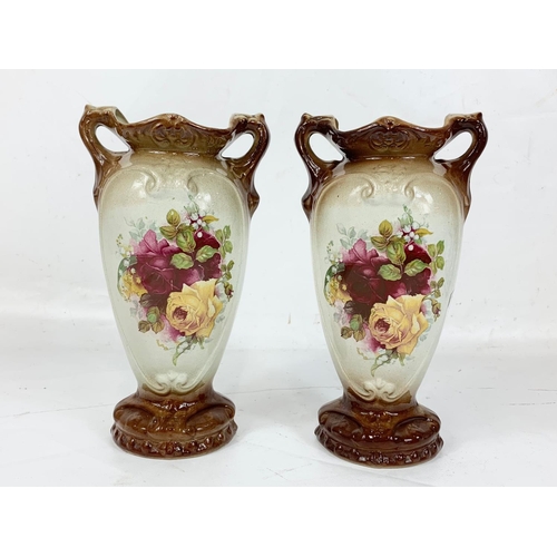 487 - A pair of Edwardian pottery vases. 25.5cm.