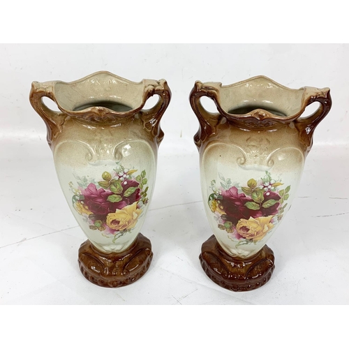 487 - A pair of Edwardian pottery vases. 25.5cm.