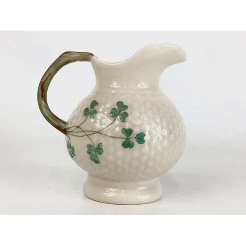 500 - A 2nd period Belleek pottery jug. 10 x 10cm.