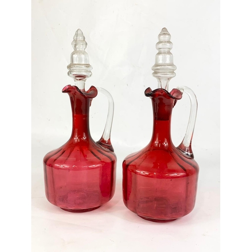 566 - A pair of Victorian Ruby Art Glass decanters. 29cm