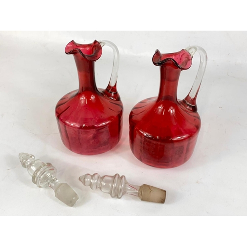 566 - A pair of Victorian Ruby Art Glass decanters. 29cm