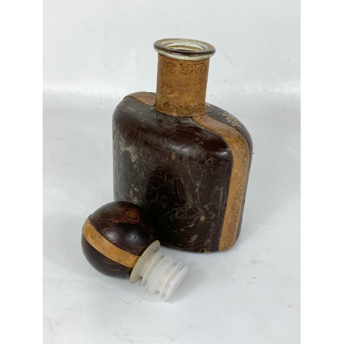 647 - A large vintage leather bound drinking flask. 16 x 26cm