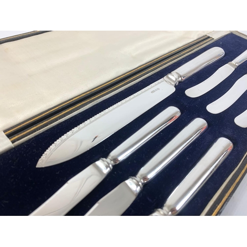 652 - A set of silver plate knives in case.